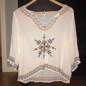 white blouse with blue and gold detail